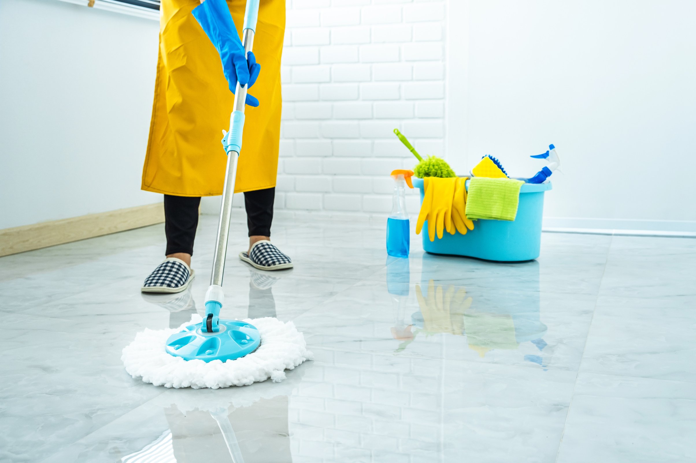 Housekeeper Cleaning the Floor with a Mop